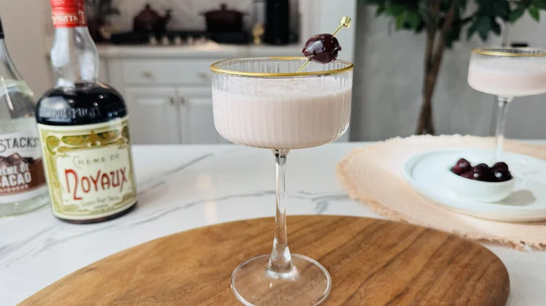 Pink squirrel cocktail with a cherry garnish