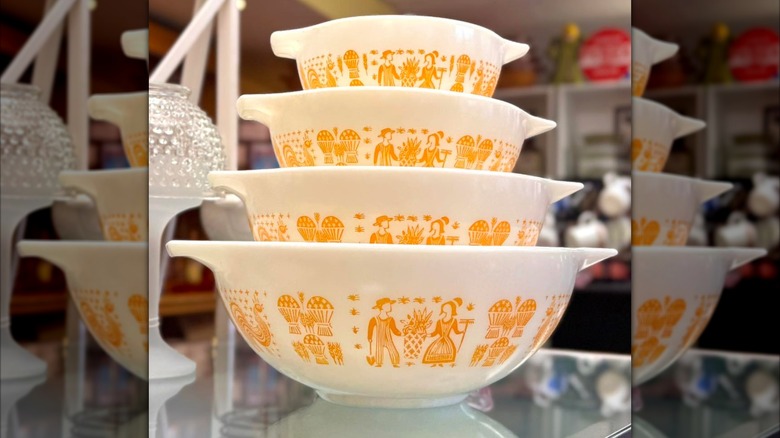 Stack of Amish Butterprint Orange Pumpkin Pyrex bowls.