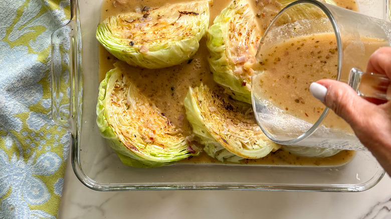 pouring sauce over cabbage