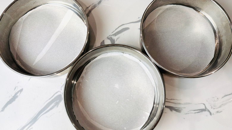 Round baking pans lined with parchment paper