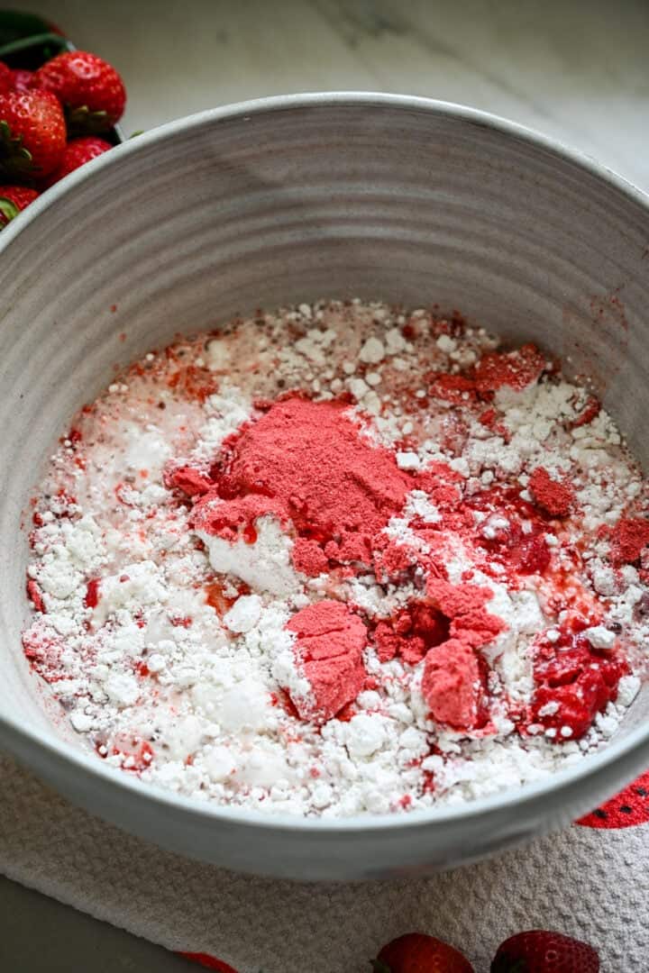 Strawberry powder, cake flour, and water in a mixing bowl.