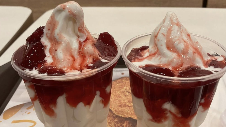 strawberry sundaes from mcdonald's sitting on a tray