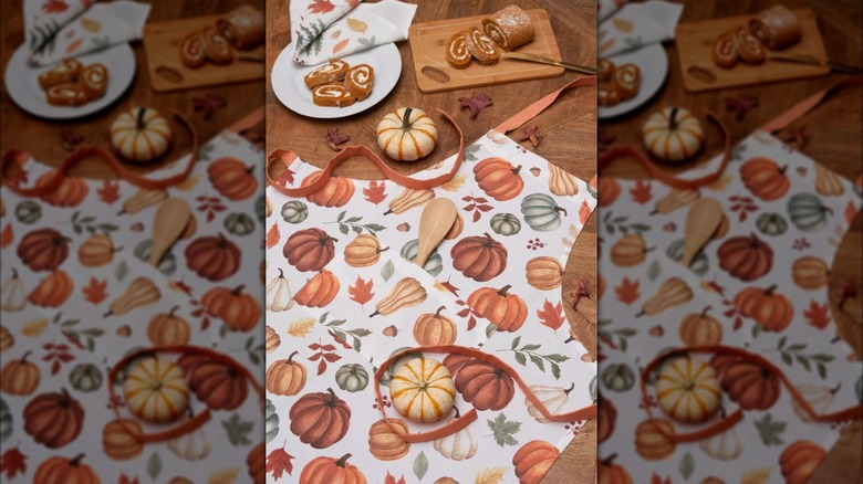 A new fall harvest apron from Target decorated with seasonal colors and a pumpkin print.