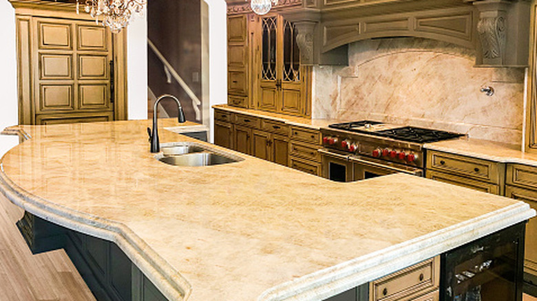 A rustic kitchen with a big island equipped with limestone