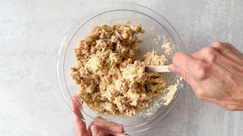 Folding lump crab into crab cake egg roll filling