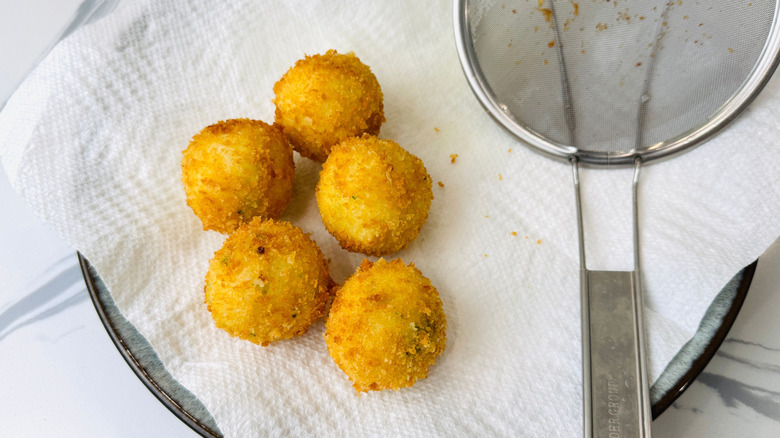 Fried mashed potato balls on paper towels