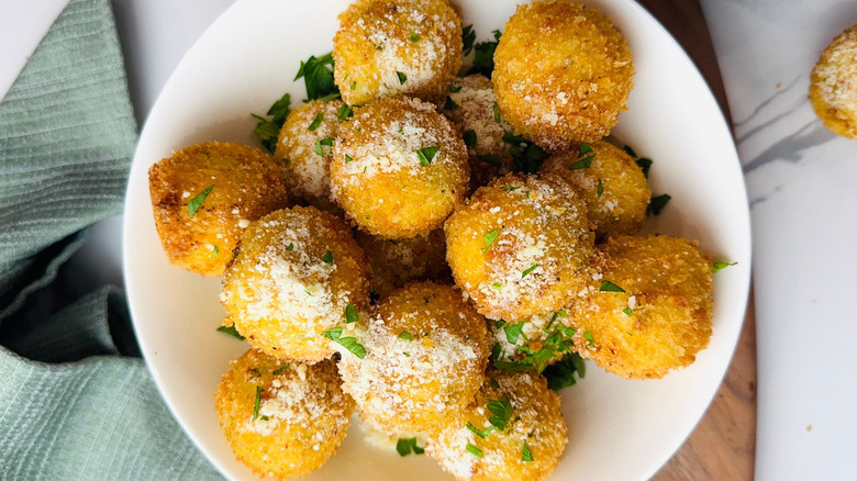 Mashed potato balls on plate with parmesan and parsley