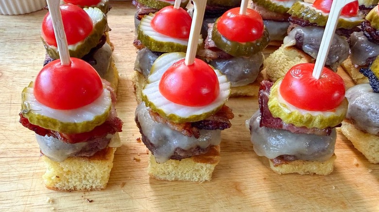 Cheeseburger skewers on cutting board