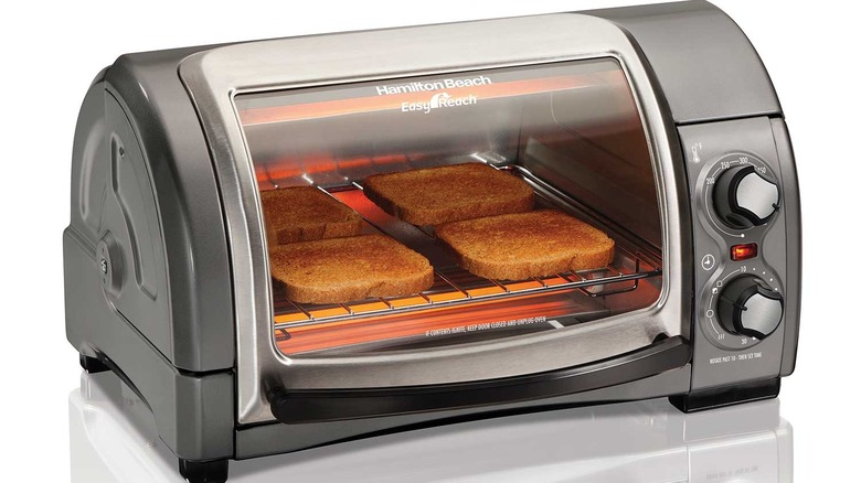 Bread toasts in the Hamilton Beach Easy Reach 4 Slice Toaster Oven with Roll-Top Door
