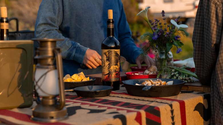 Bottle of Juggernaut Cabernet on outdoor table with food