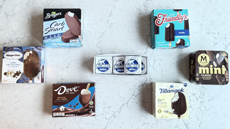 Boxes of popular ice cream bars are fanned on a marble countertop