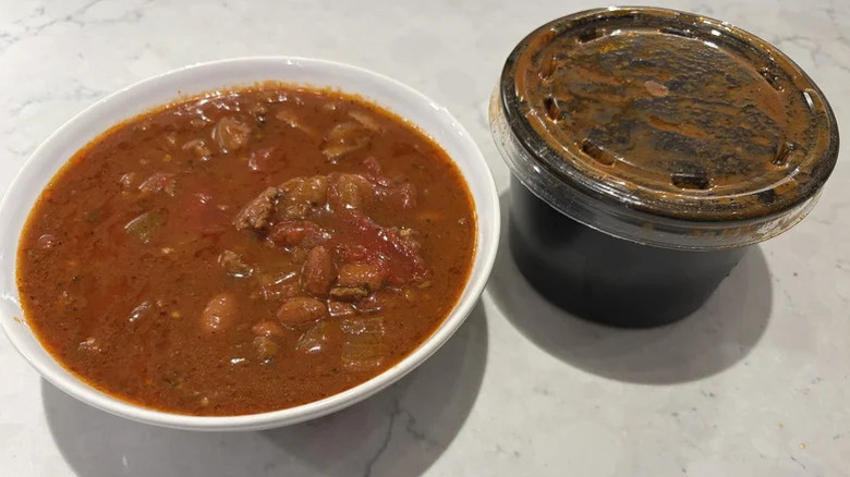 A bowl of chili from the Quiznos sandwich chain sits atop a white counter.