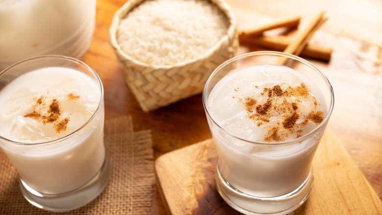 Two glasses of horchata topped with cinnamon.