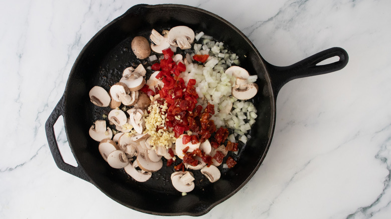 A large skillet filled with assorted vegetables