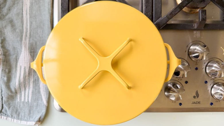 Covered yellow Dutch oven on stovetop