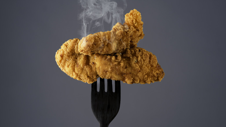 Steaming hot chicken tenders on a fork