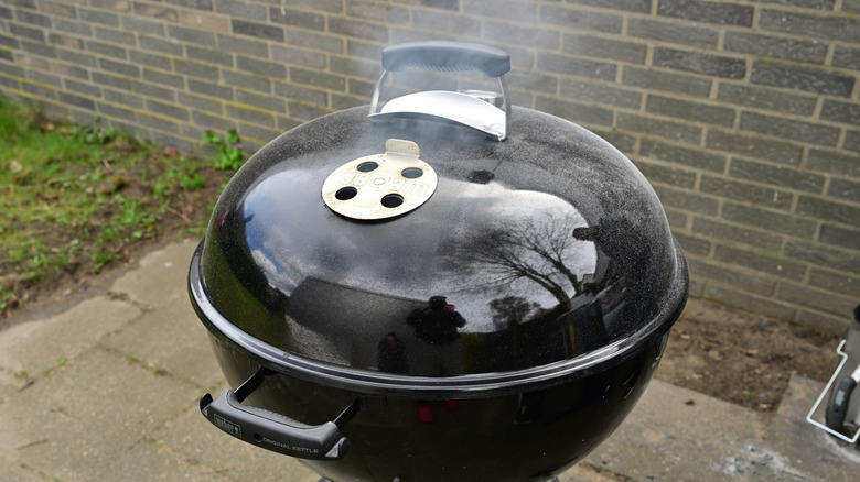 An outdoor grill with smoke