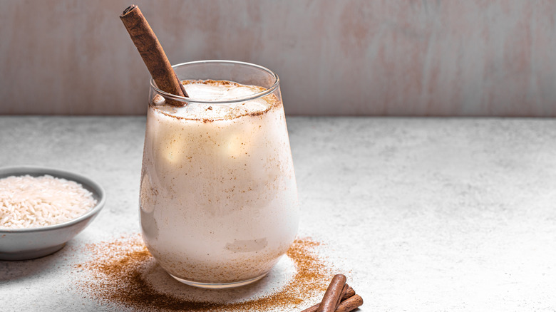 horchata in a glass with a cinnamon stick