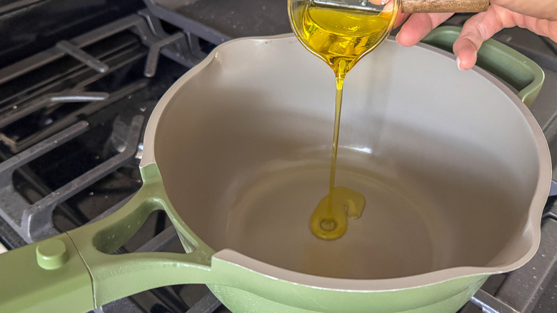 Oil pouring into saucepan