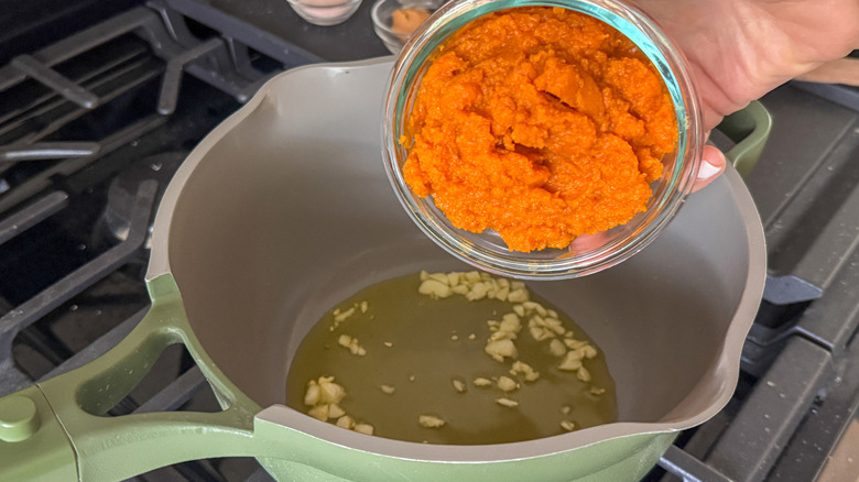 Pumpkin puree going into saucepan