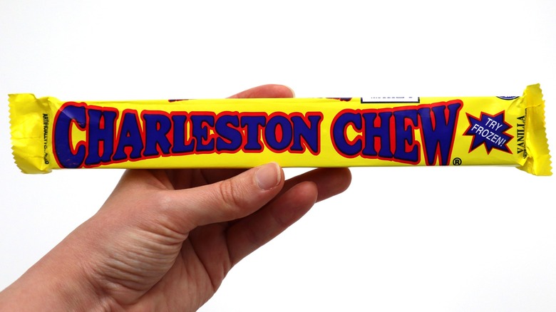 A hand holds a wrapped Charleston Chew