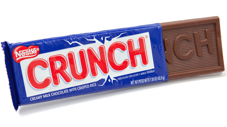A Crunch bar peeks out of its wrapper