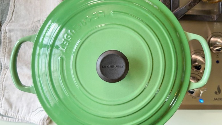 Green covered Dutch oven on stovetop