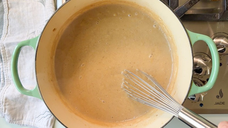 Whisking miso paste into vegan Nordic-style creamy cabbage soup