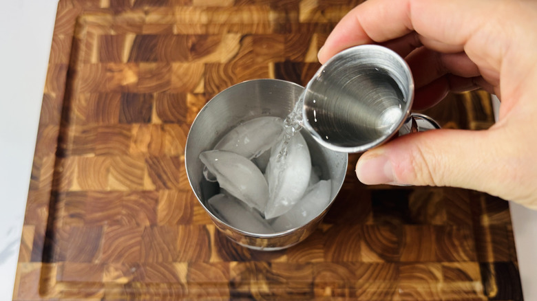 Adding cachaça to a cocktail shaker