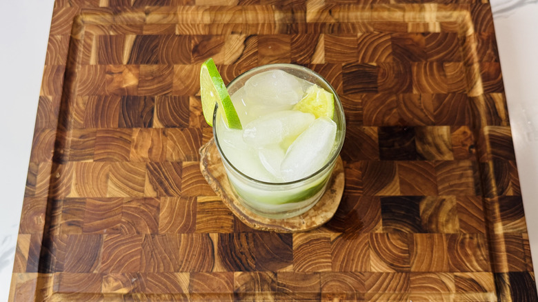 Caipirinha cocktail in a rocks glass with lime slice