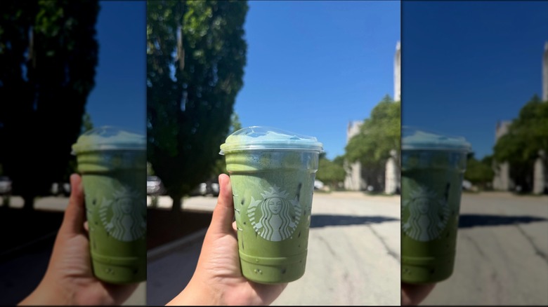 Hand holding  Starbucks Iced Blue Coconut Matcha