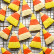 Overhead view of a wire cooling rack covered with baked candy corn shortbread cookies.
