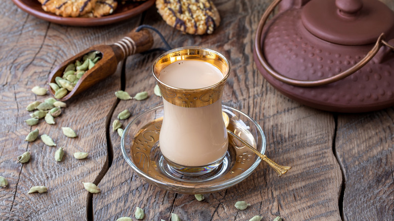 Cardamom pods are arranged around a latte.