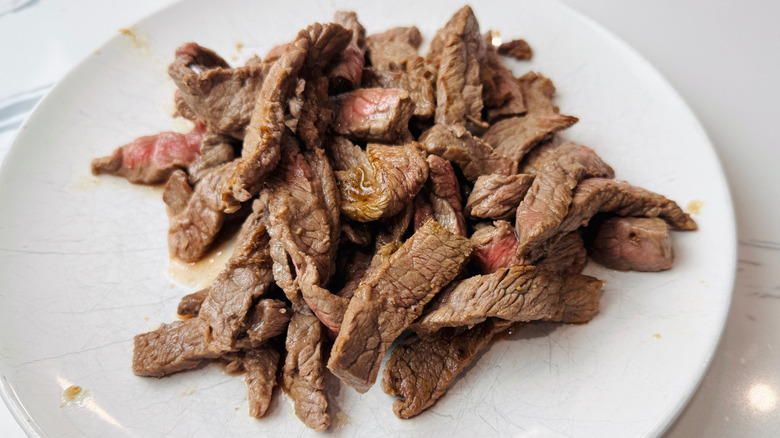 Cooked beef strips on plate