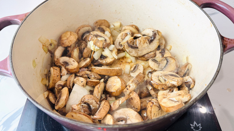 Sliced mushrooms and onion in Dutch oven