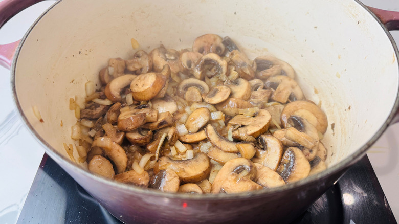 Cooked mushrooms and onion in Dutch oven