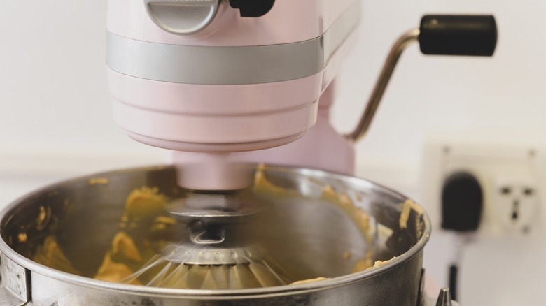 Pink KitchenAid stand mixer whisking at full speed.