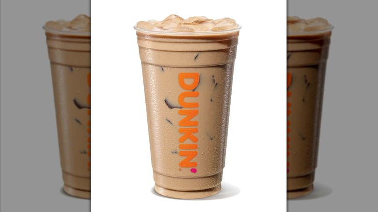 Caramel Chocolate Iced Protein Latte in Dunkin' clear plastic cup on a white background