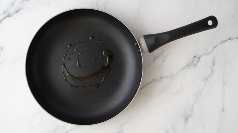 A nonstick skillet drizzled with olive oil