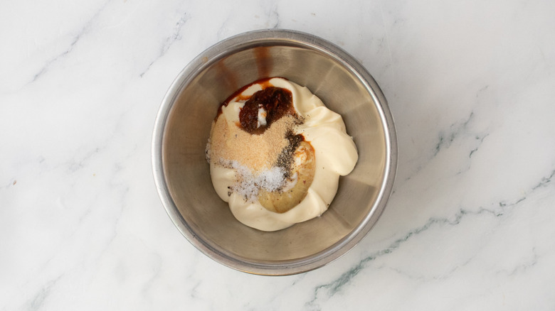 A medium bowl filled with special sauce ingredients
