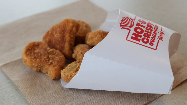 Wendy's chicken nuggets spilling from their container.