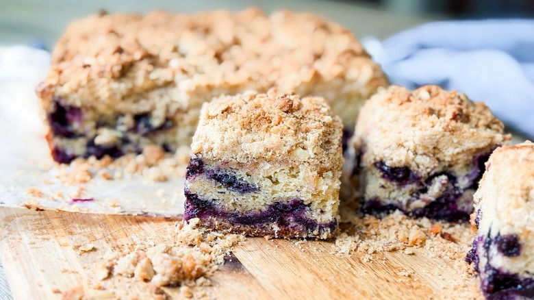 Close-up of blueberry crumb cake slice on cutting board