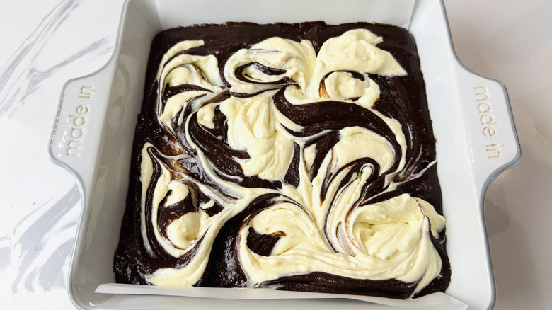 Brownie batter topped with cream cheese swirl