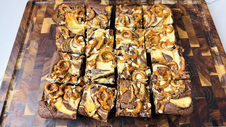 Cut caramel pretzel brownies on cutting board