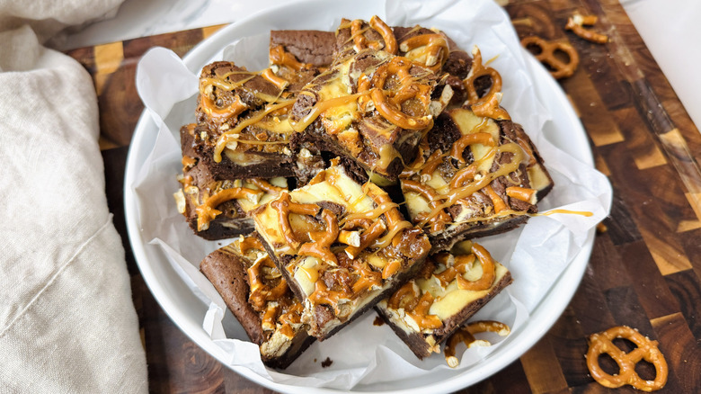 Stack of caramel pretzel brownies in bowl