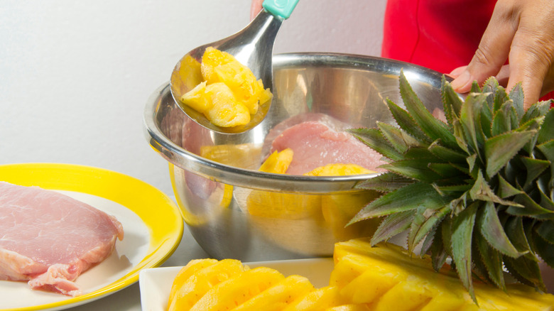 Pork being marinated with pineapple.
