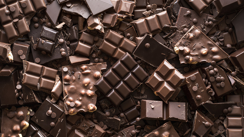 Pile of broken chocolate bars, baking chocolate squares, and chocolate chips