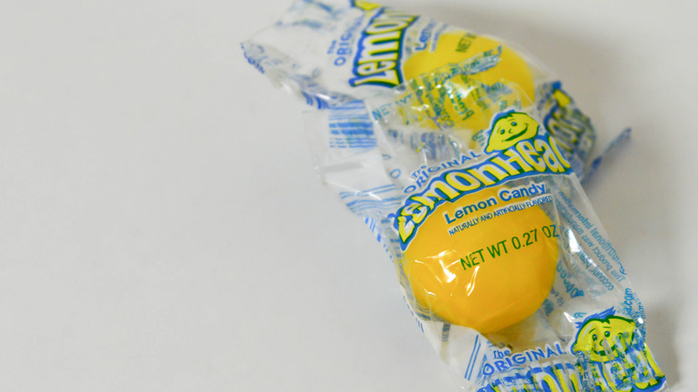 Two individually wrapped Lemonhead candies.