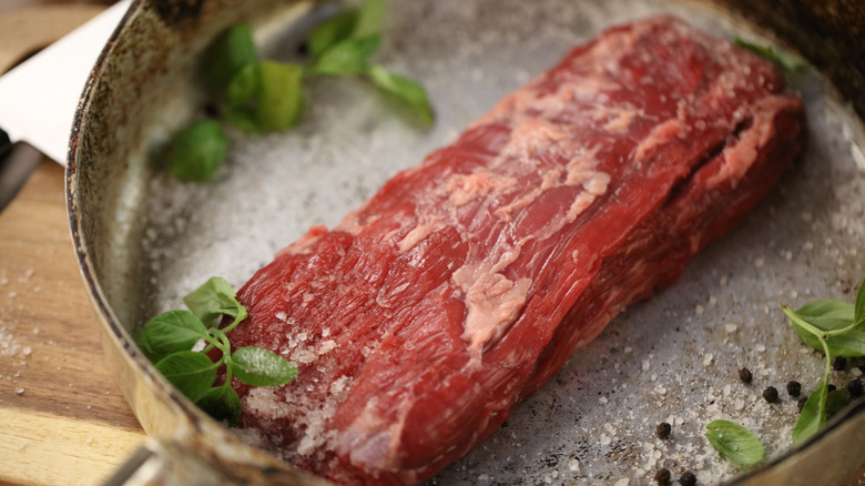 A raw bavette steak on a plate.