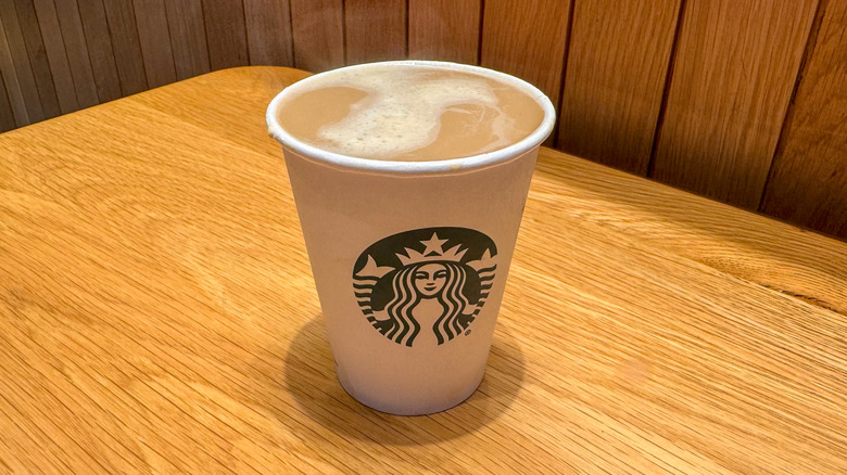 Cortado in a cup with wooden background